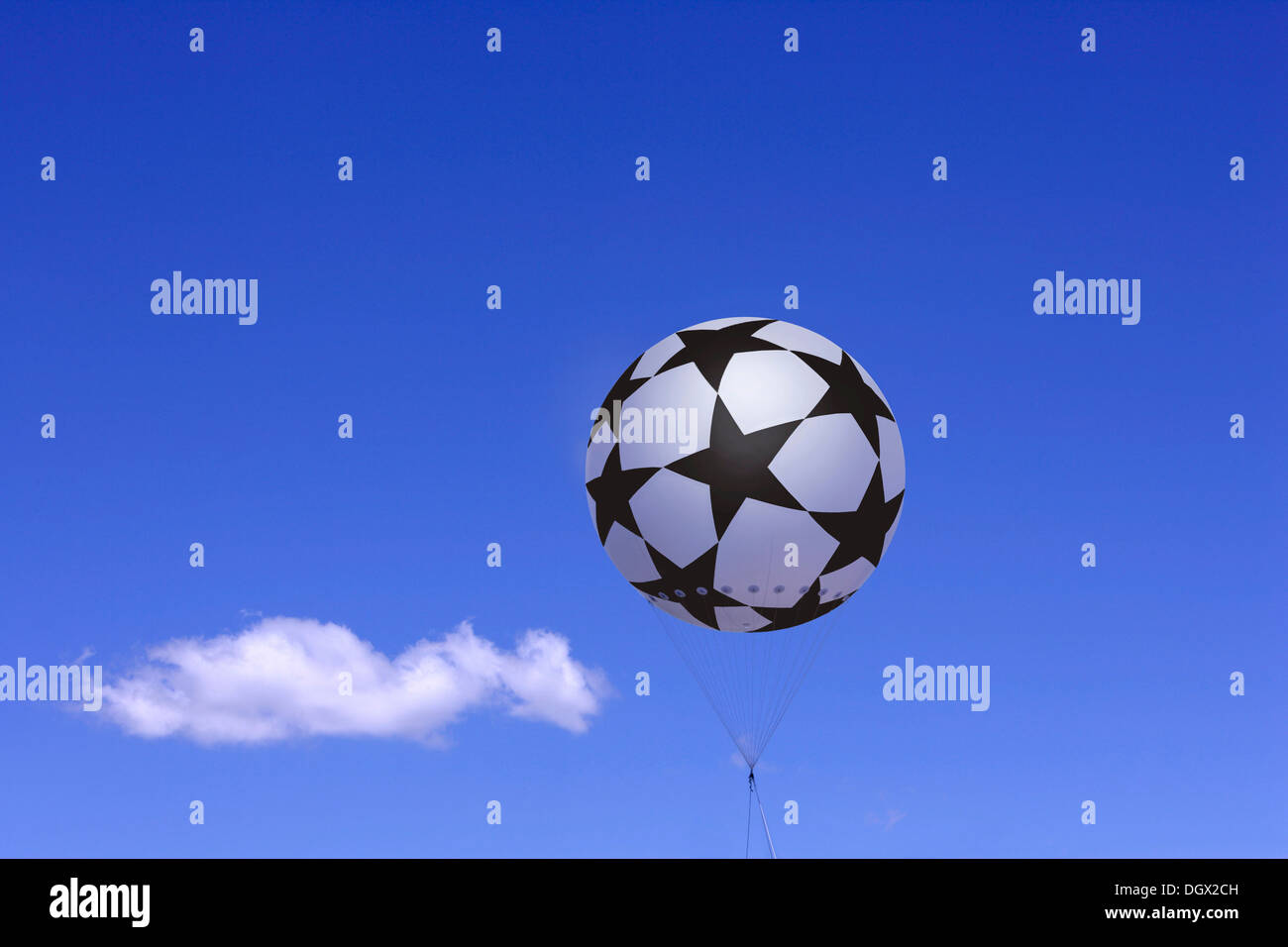 Tethered balloon with the Champions League logo against a blue sky with a cloud, Bavaria, Germany Stock Photo