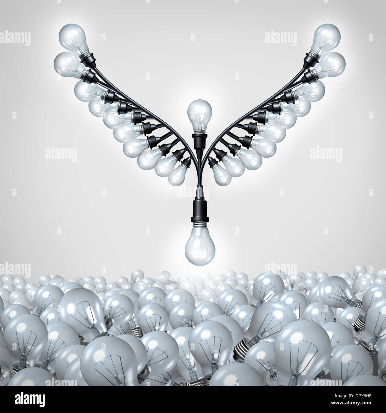 Successful ideas as a business metaphor for creative innovation taking off as a group of organized light bulbs shaped as open bird wings rising up out of a mountain using the bulb icon as a symbol of the power of imagination and intelligence. Stock Photo