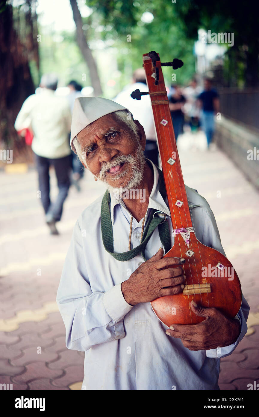 An Old Indian musician holding his Sitar - street scene - Mumbai, India Stock Photo