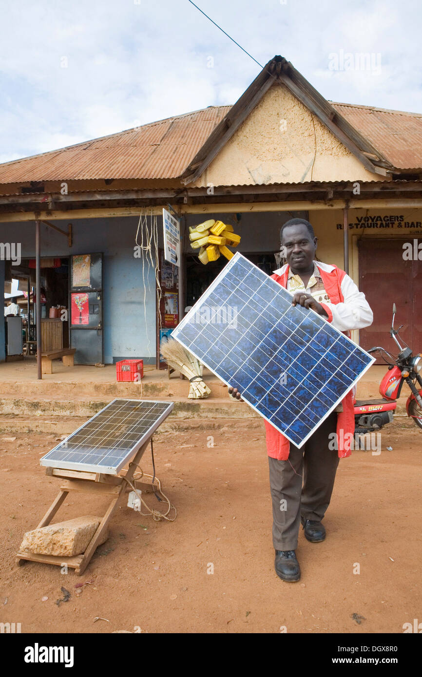 Mr. Tinkasimire, owner of an electrical shop, offering products like Premier Modul solar panels, Masindi, Uganda, Africa Stock Photo