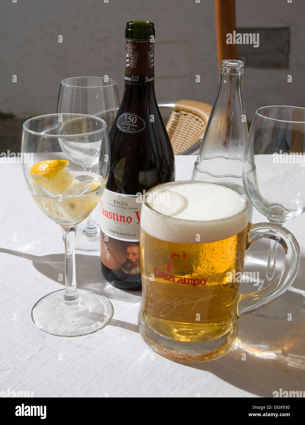 Large glass Cruzcampo beer Spain with glasses of water and  bottle red wine on table Stock Photo