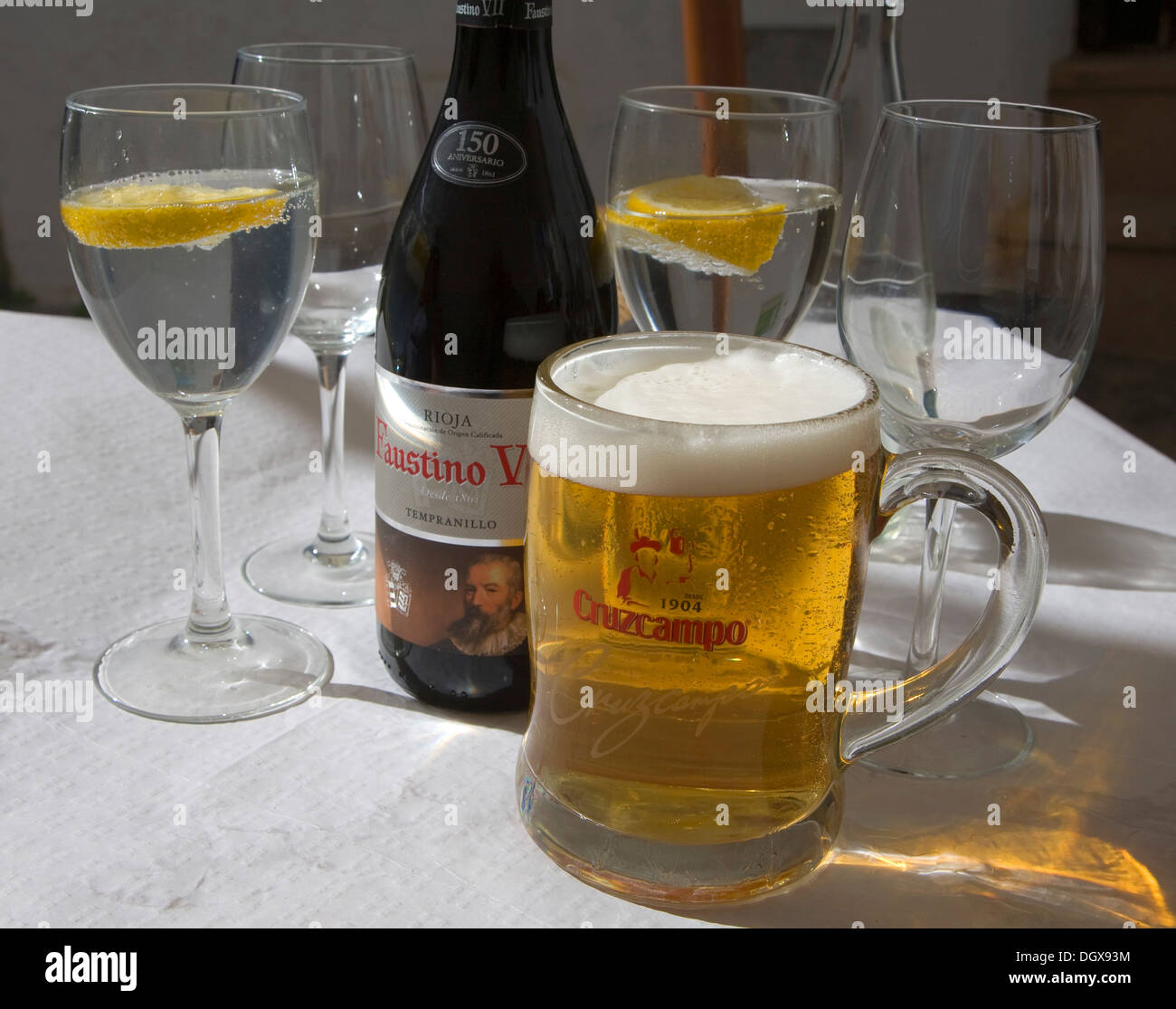 Large glass Cruzcampo beer Spain with glasses of water and  bottle red wine on table Stock Photo