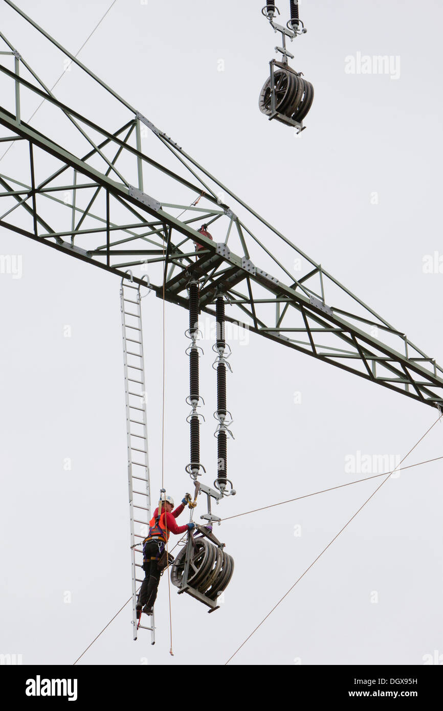 Lineman working with a wire rope hoist on a 380kV longdistance line