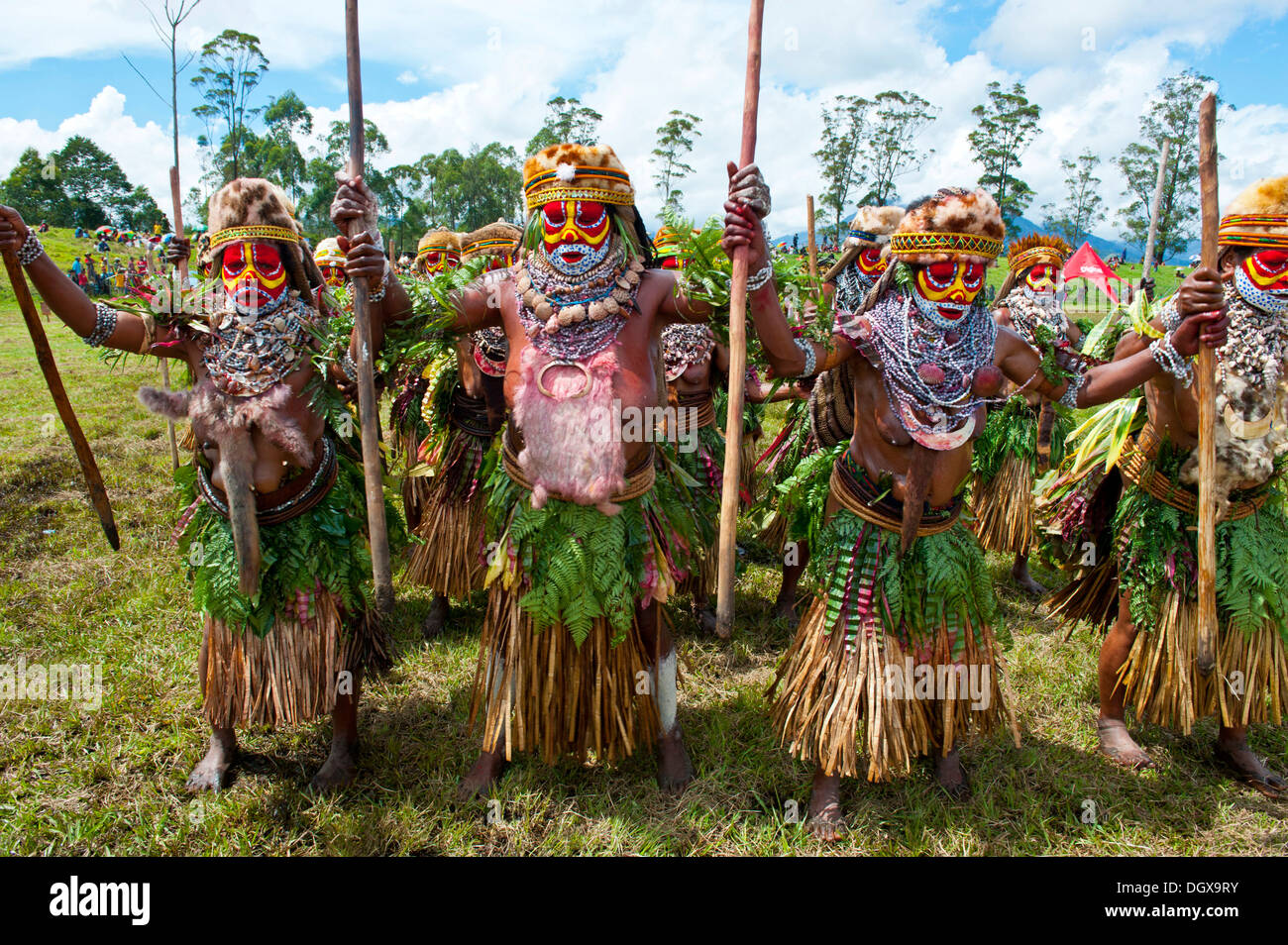 Members of a tribe in colourfully decorated costumes with face paint at ...