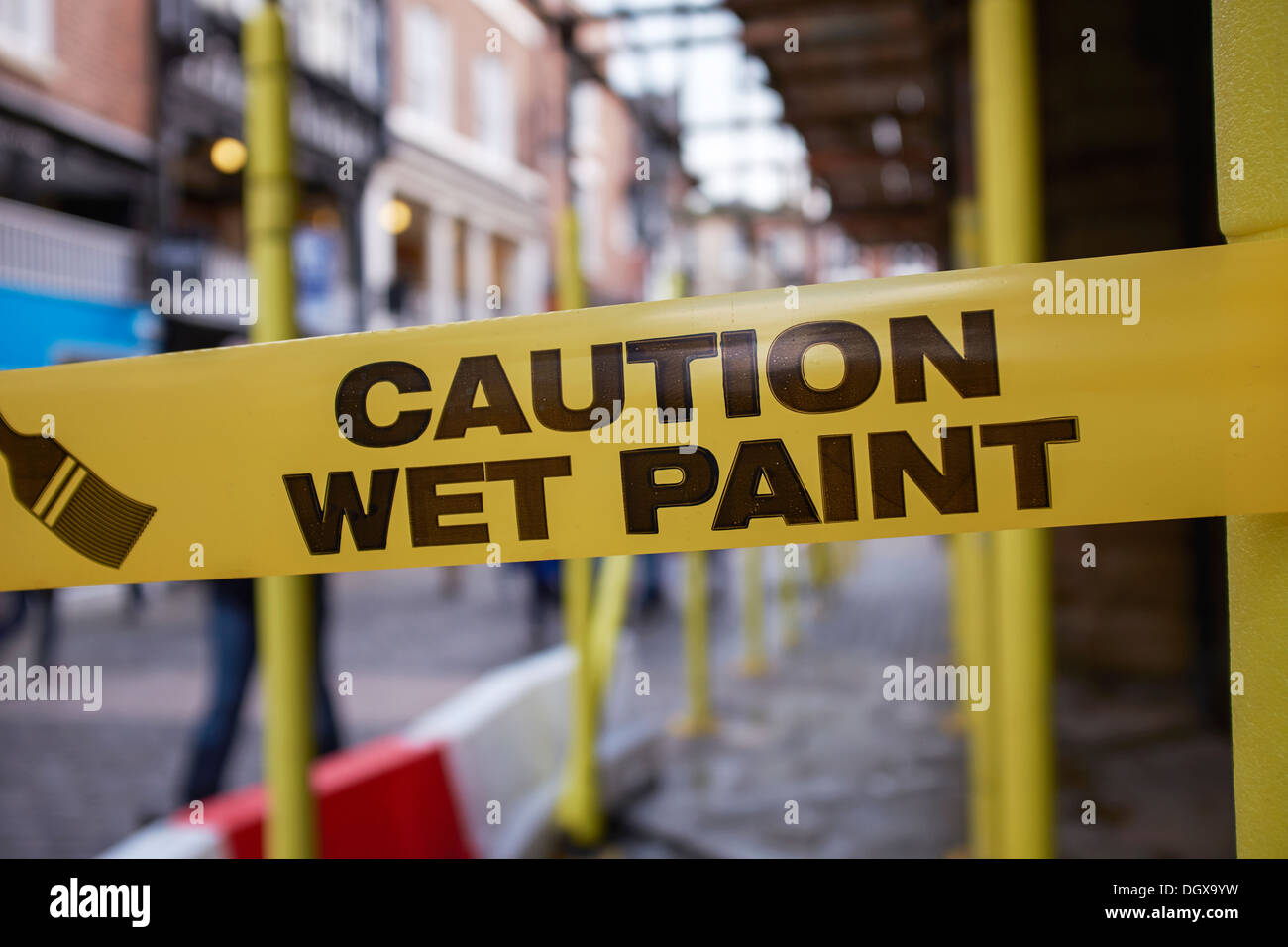 Caution Wet Paint warning tape tied around scaffolding Stock Photo