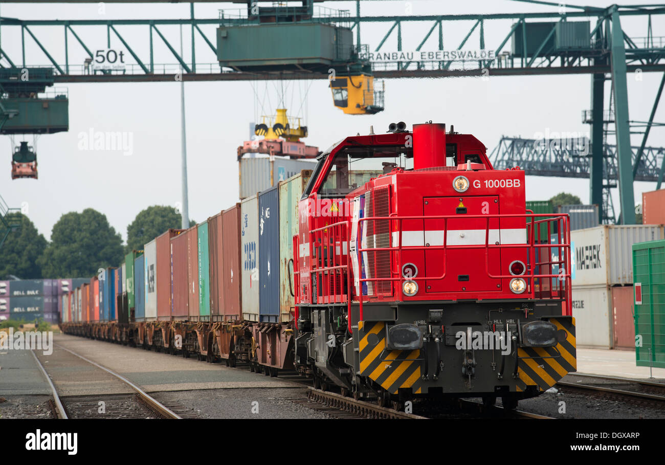 Freight train being loaded with containers Stock Photo Alamy