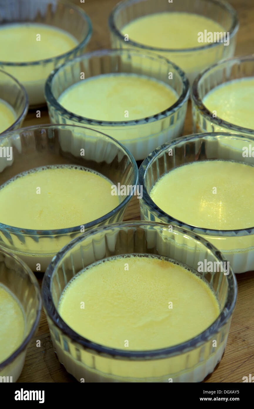 Freshly made crème caramels in individual glass ramekins Stock Photo