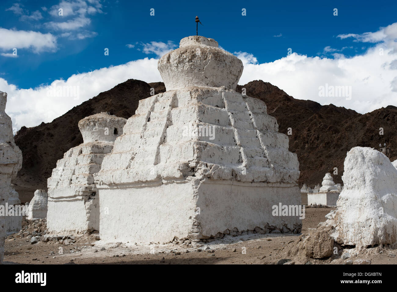 Buddhist stupa ( chorten ) over Himalaya high mountain landscape with cloudy blue sky India, Ladakh, Leh valley Stock Photo