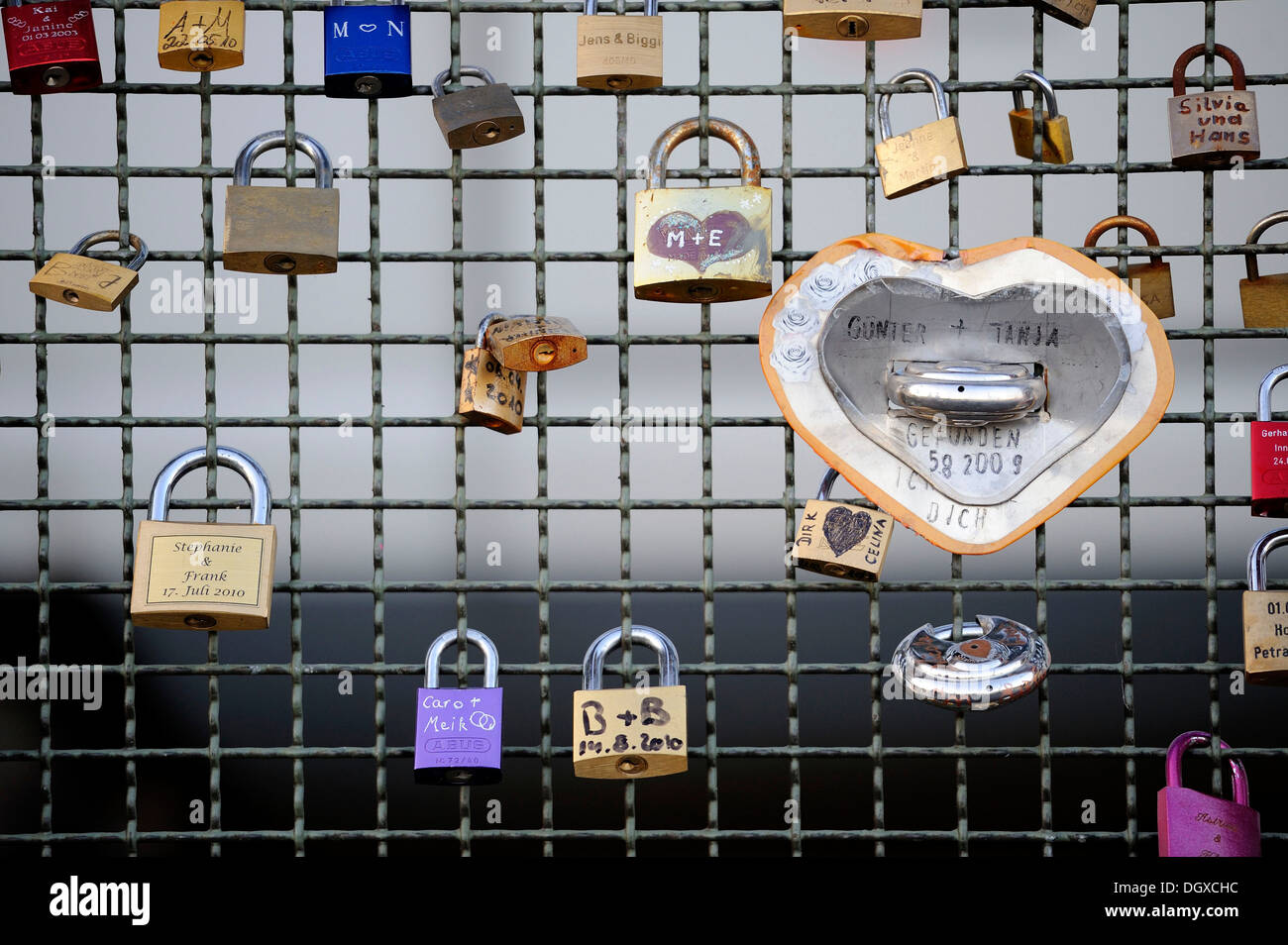 Mesh fence with padlocks and heart, Cologne, North Rhine-Westphalia Stock Photo