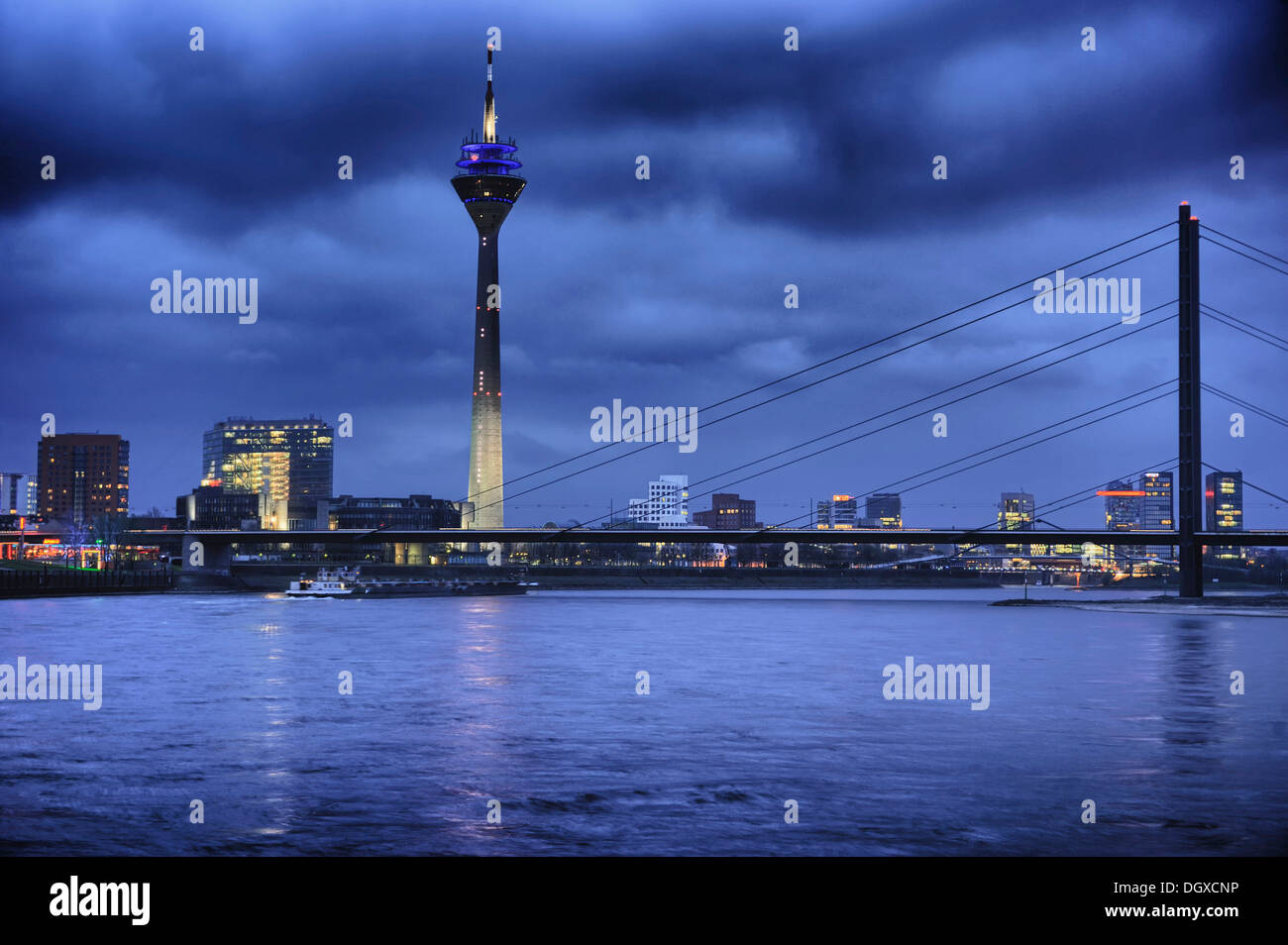 Rheinturm tower with the Rhine and the skyline at dusk, Medienhafen, Media Harbour, Duesseldorf Rheinturm tower with the Rhine and the skyline at dusk, Medienhafen, Media Harbour, Duesseldorf