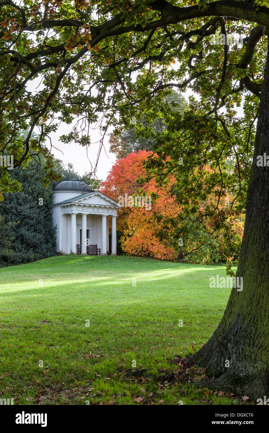 The Temple of Bellona and tree with autumn orange foliage - Kew Gardens, Greater London UK Stock Photo