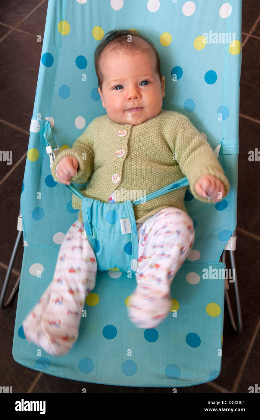 Portrait of little baby girl in a baby bouncer Stock Photo