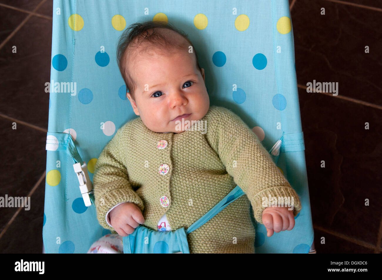 Portrait of little baby girl in a baby bouncer Stock Photo