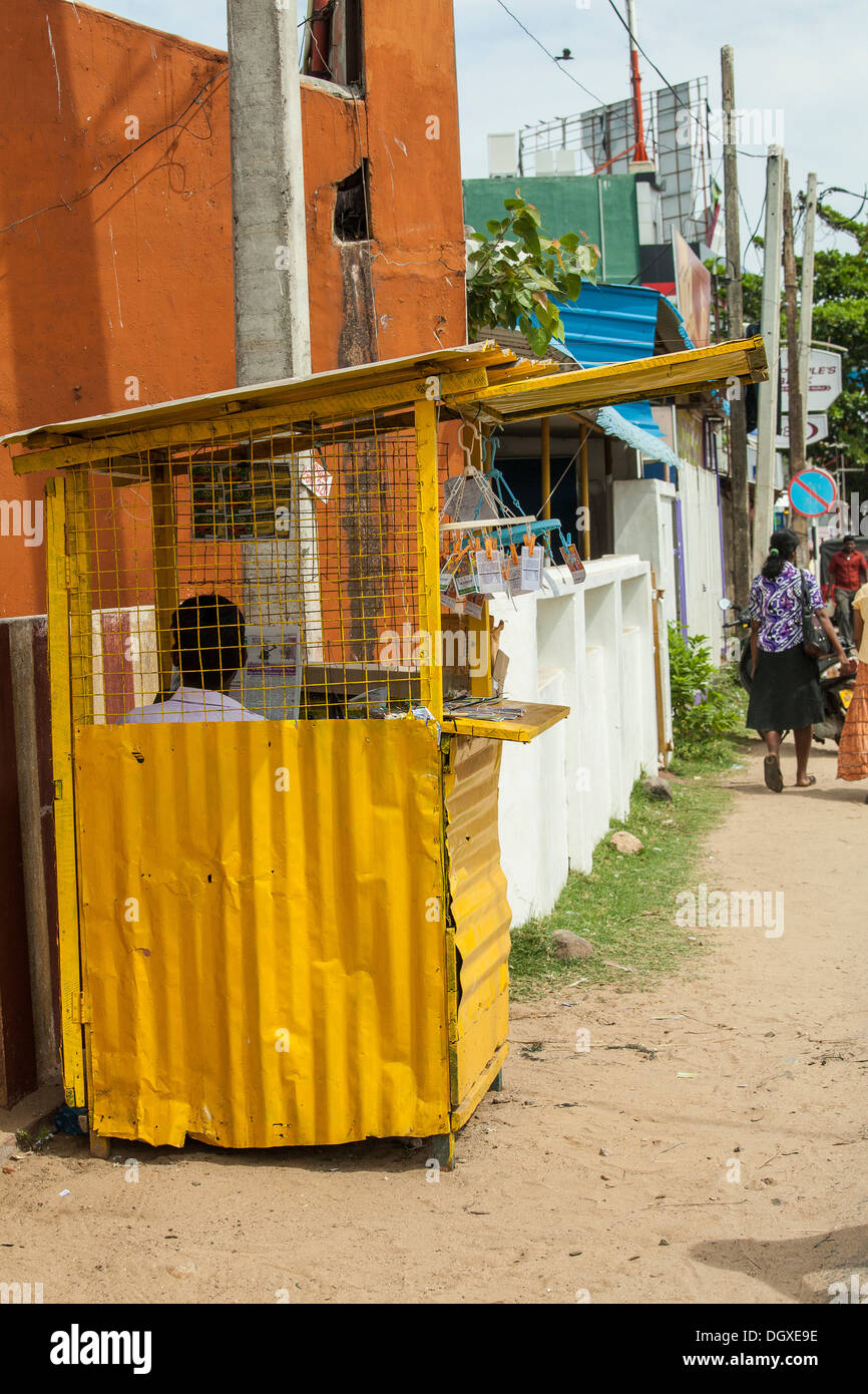 Man sells lottery tickets in a simple booth in Trincomalee Stock Photo