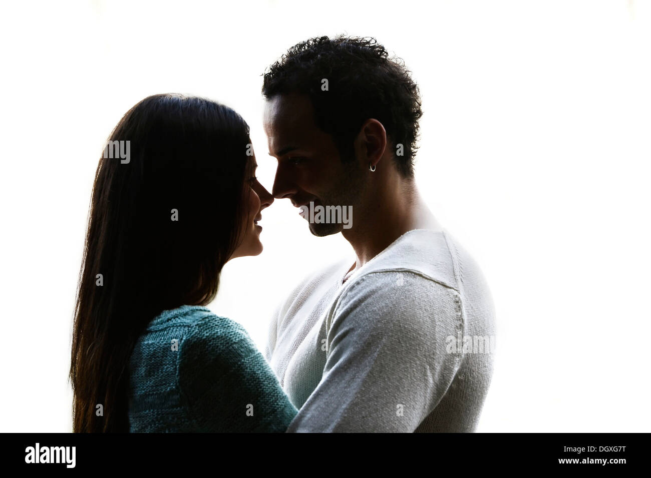 Young couple looking into each other's eyes, backlit, Austria Stock Photo