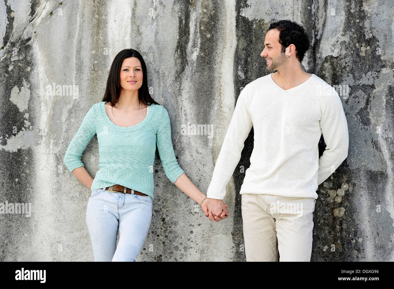 Young man standing front wall hi-res stock photography and images - Alamy