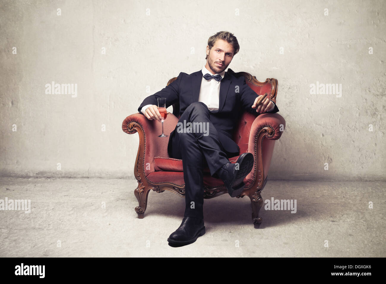 Gentleman sitting on a vintage armchair Stock Photo