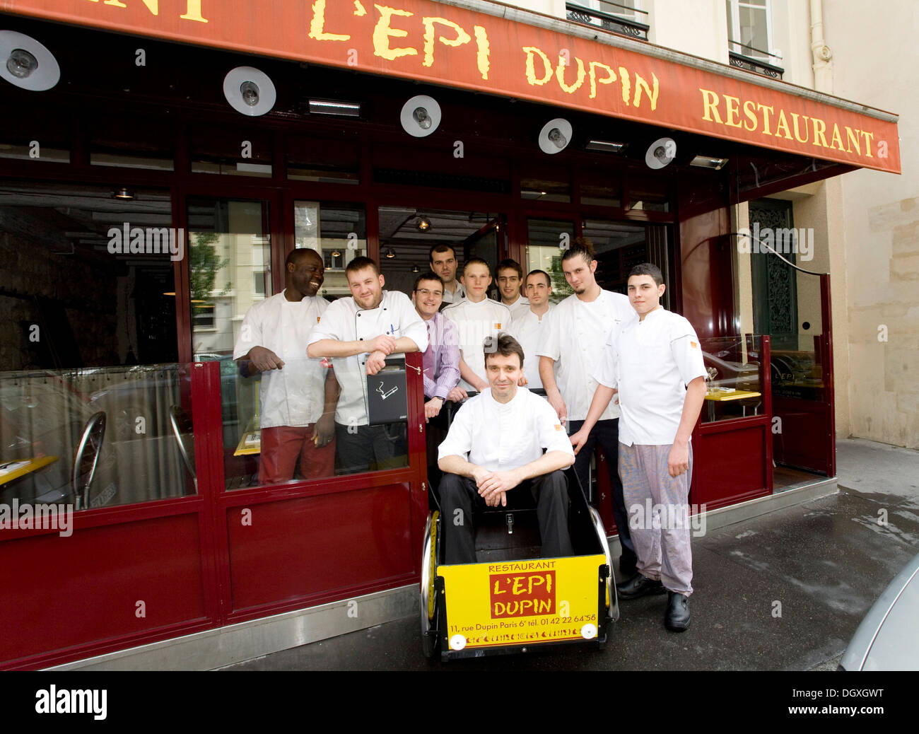 Service crew from the L'Epi Dupin restaurant, head chef Francois Pasteau seated in a wagon, 6th Arrondissement, Paris, France Stock Photo