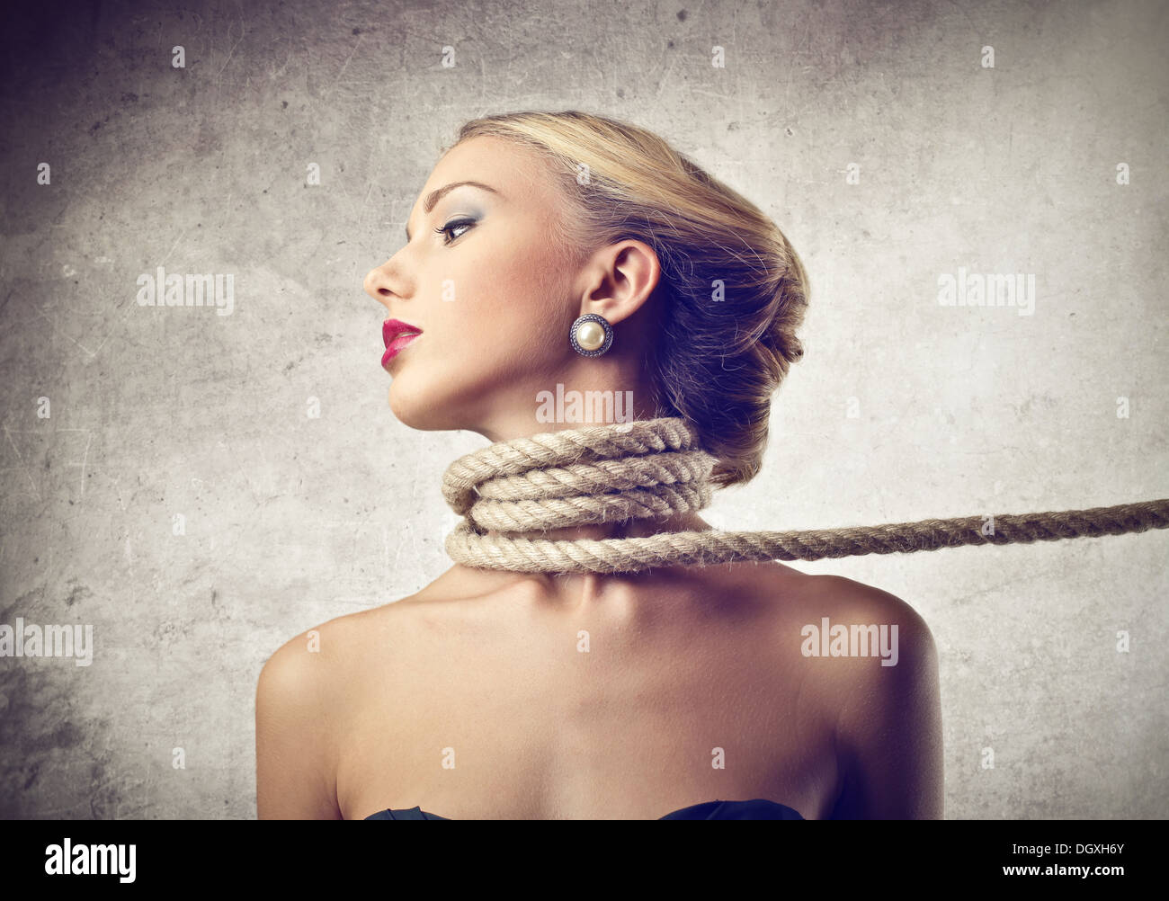 Beautiful blonde girl with a rope tied around the neck Stock Photo