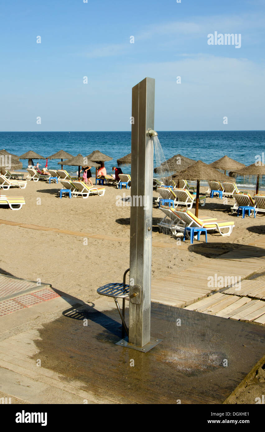 Modern Beach shower, with sunbeds behind in Fuengirola, Southern Spain