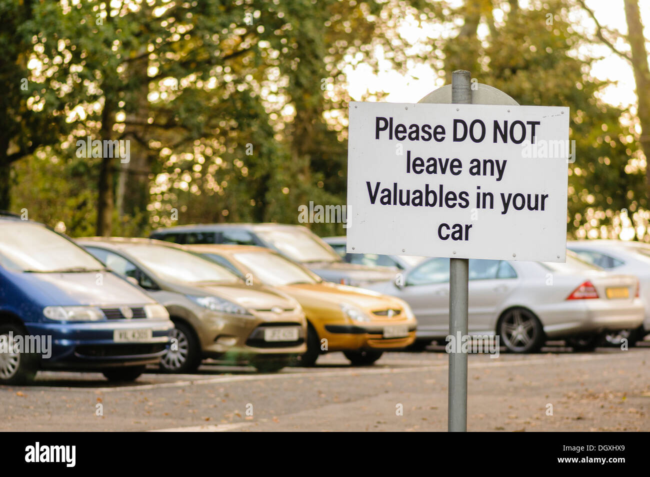 Sign in a car park warning drivers not to leave any valuables in their car Stock Photo