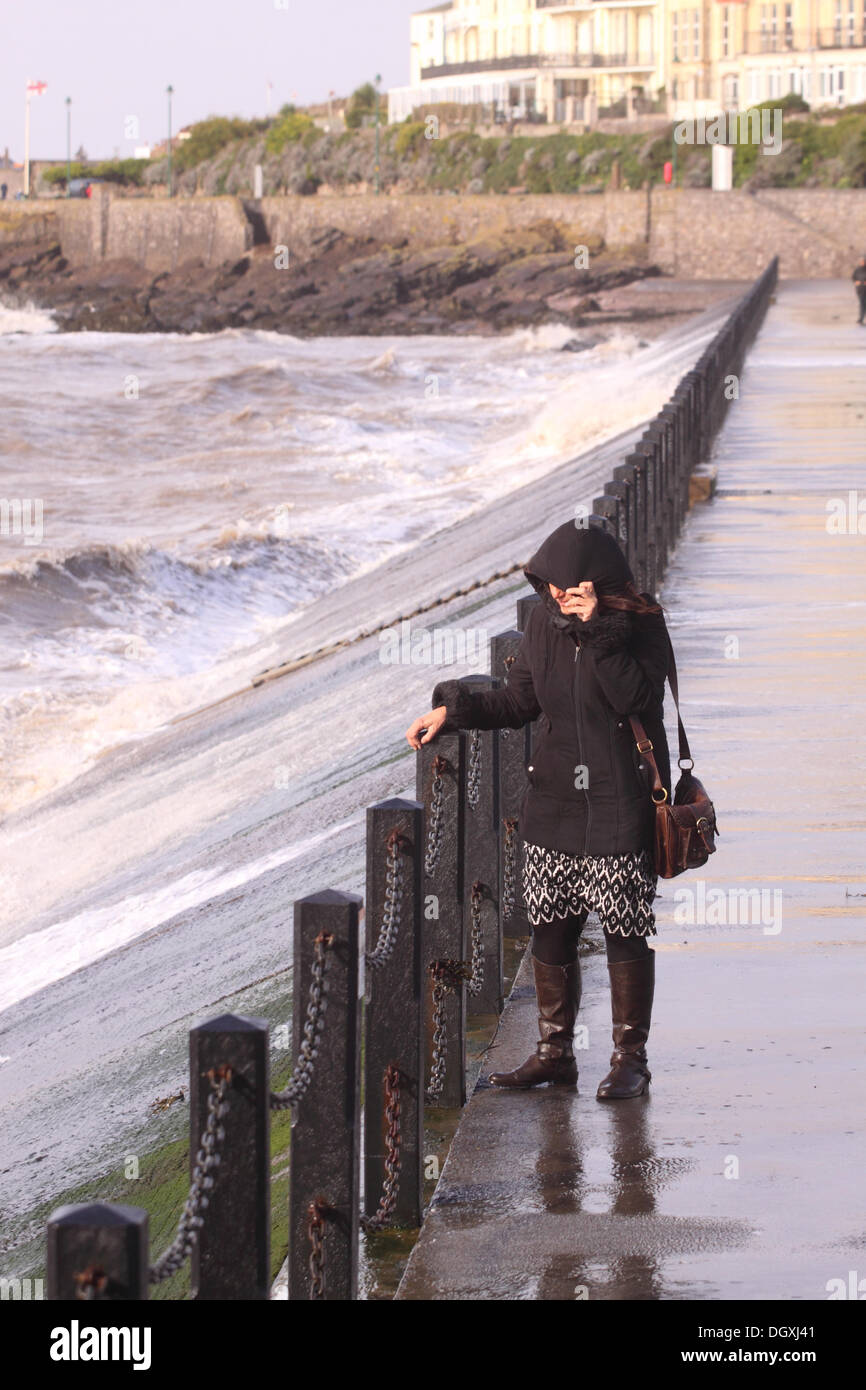 Weston Super Mare, Somerset, October 2013 – Strong winds on the West coast and a high tide soak visitors as they walk across the sea wall at Marine Lake, Weston Super Mare Stock Photo