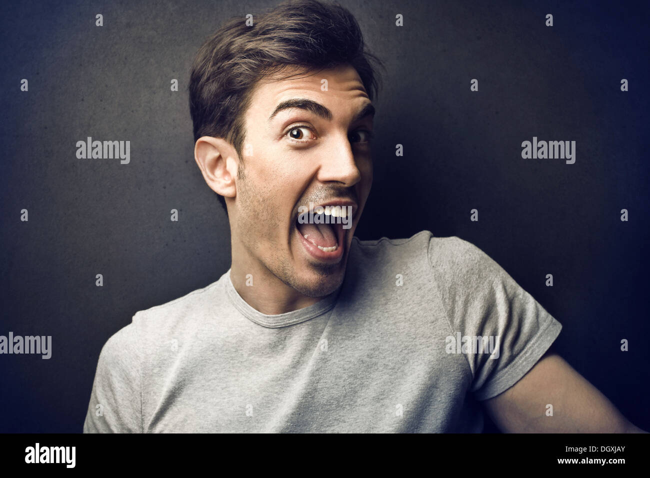 Happy boy screaming with a black background Stock Photo
