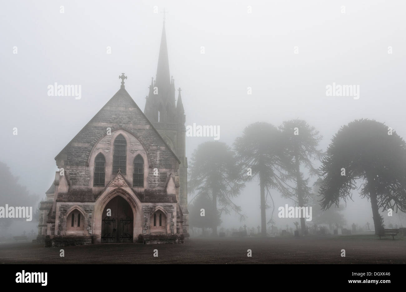 Old Church in a creepy foggy cemetery Stock Photo