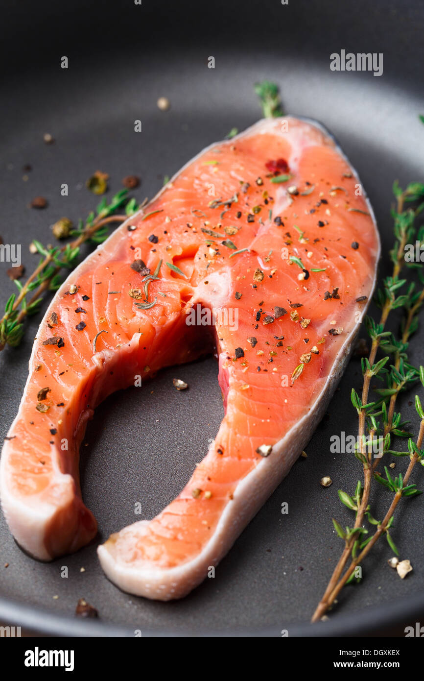 Salmon steak with thyme and pepper Stock Photo Alamy