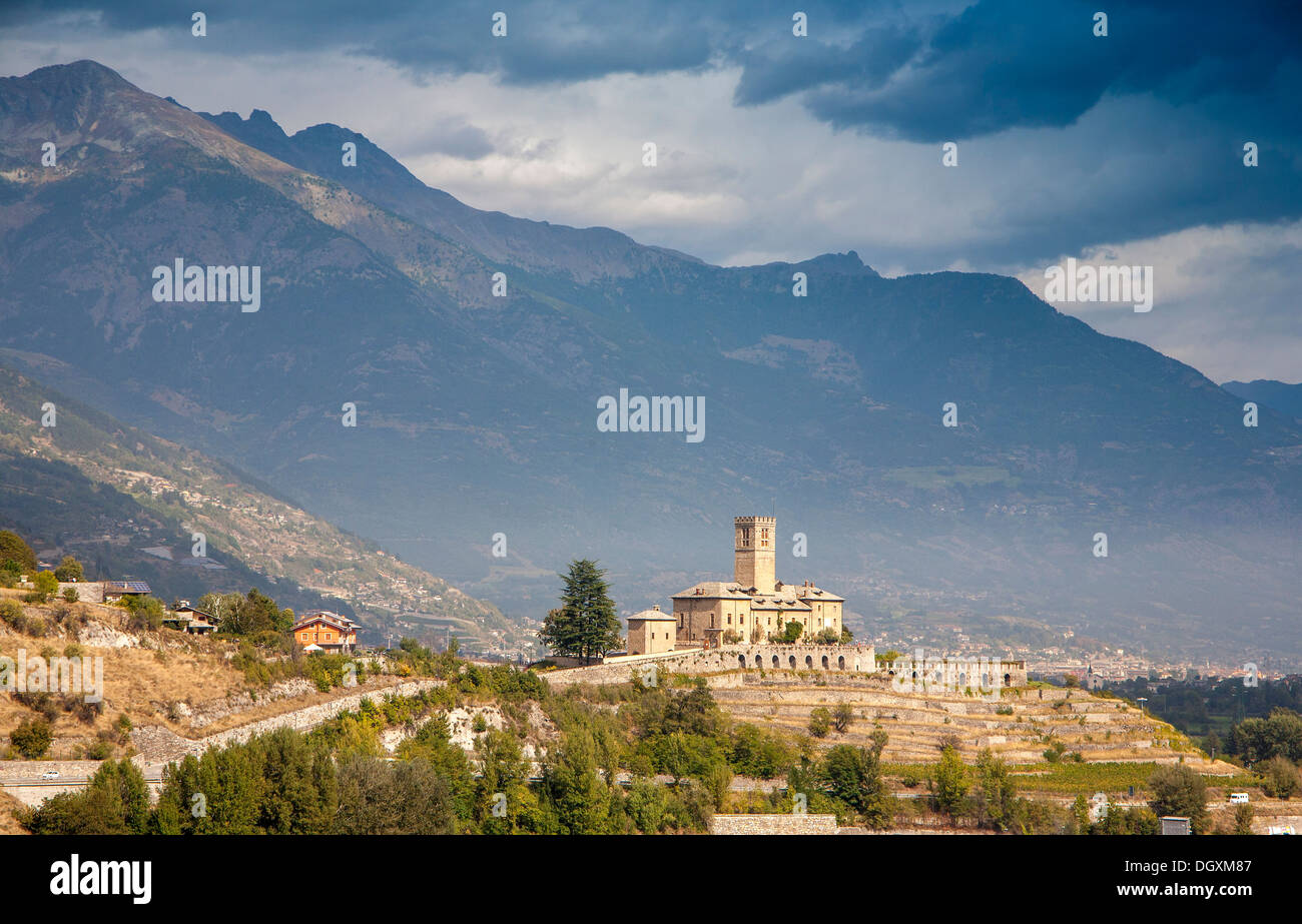 Italian renaissance castle against dark mountains and threatening sky. Stock Photo