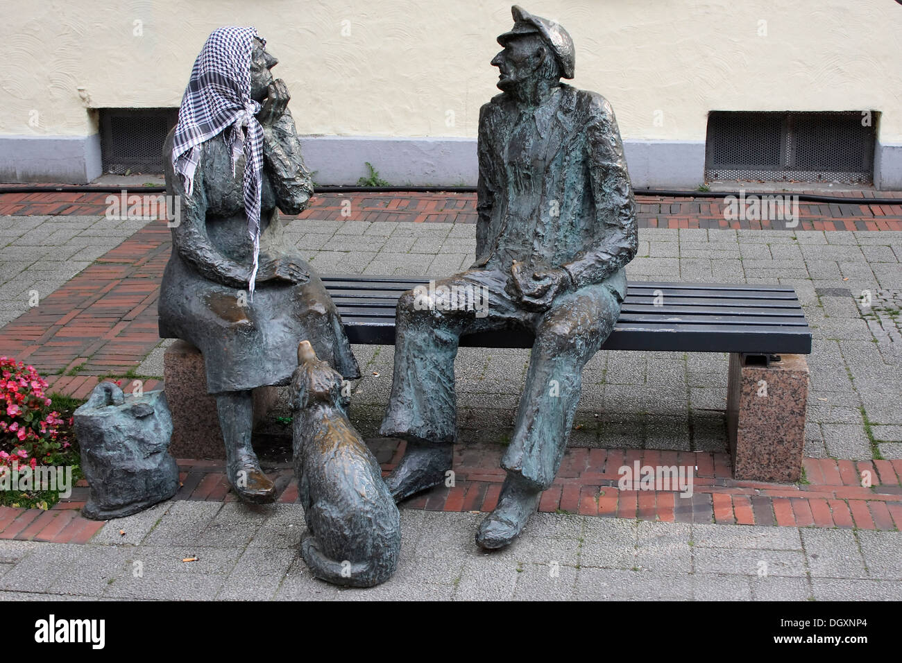 Sculptures on a bench, man and woman in a pedestrian zone in Aurich, East Frisia, Lower Saxony Stock Photo