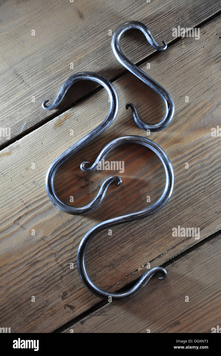 Three decorative butcher's hooks Stock Photo Alamy