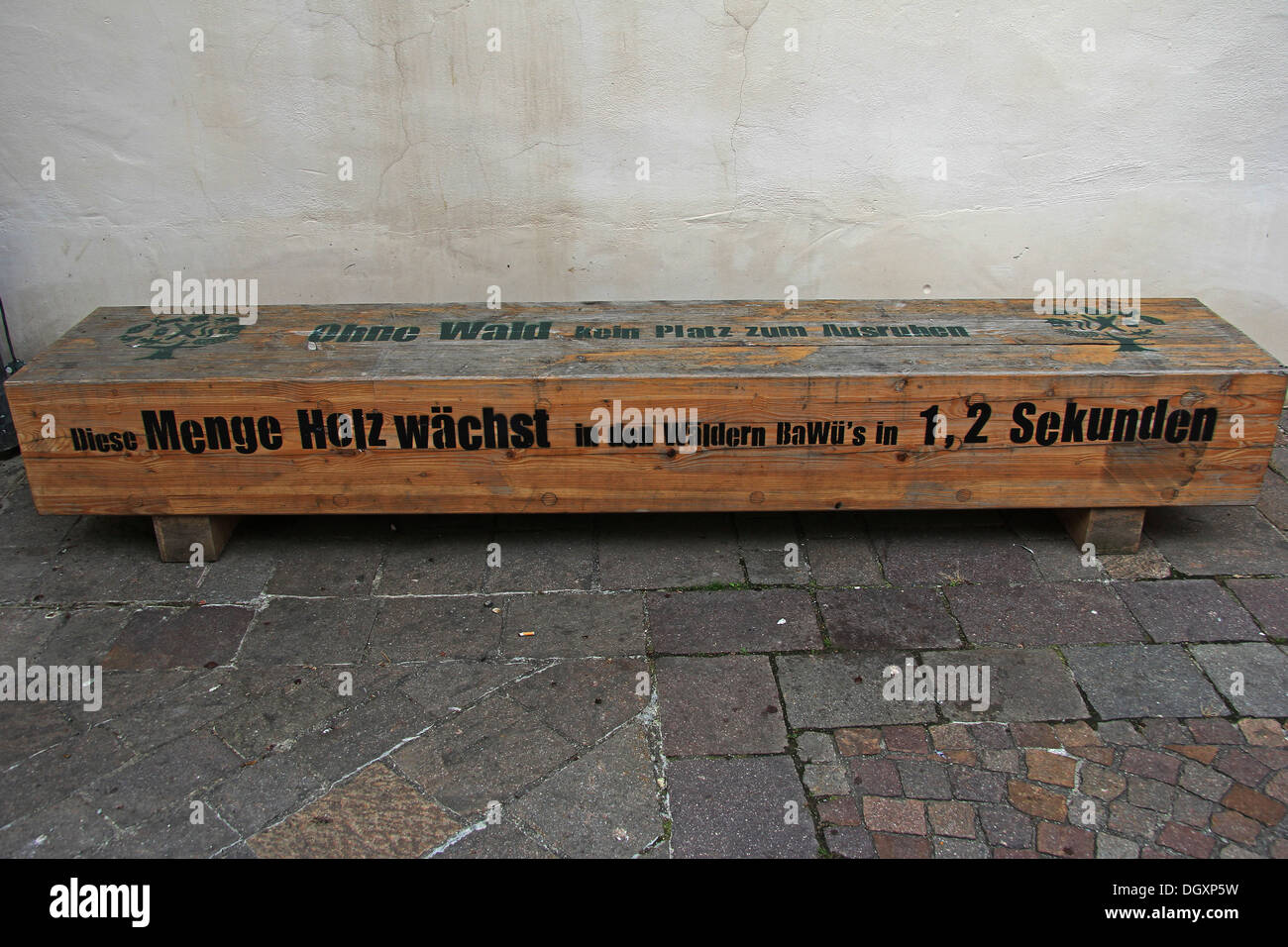 Wooden bench with a note 'Ohne Wald kein Platz zum Ausruhen', English for 'without forests, there is no place to rest' Stock Photo