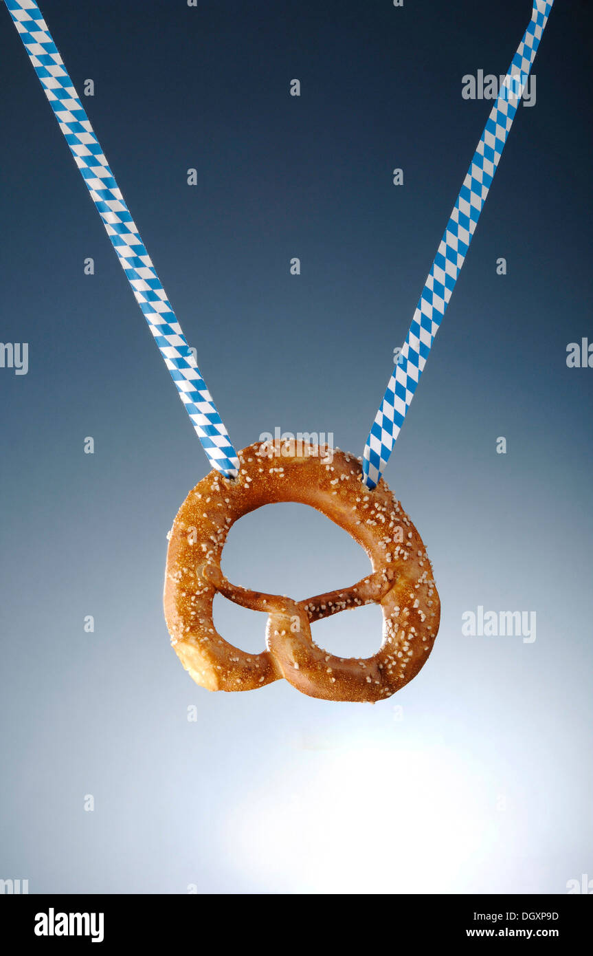 Pretzel hanging on a white and blue ribbon Stock Photo
