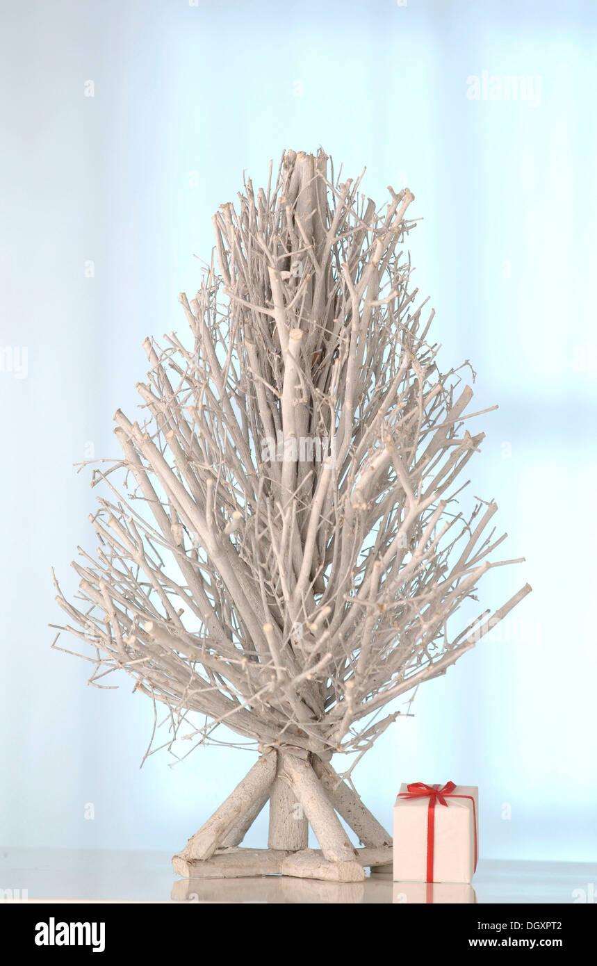 White tree made of twigs with a gift Stock Photo