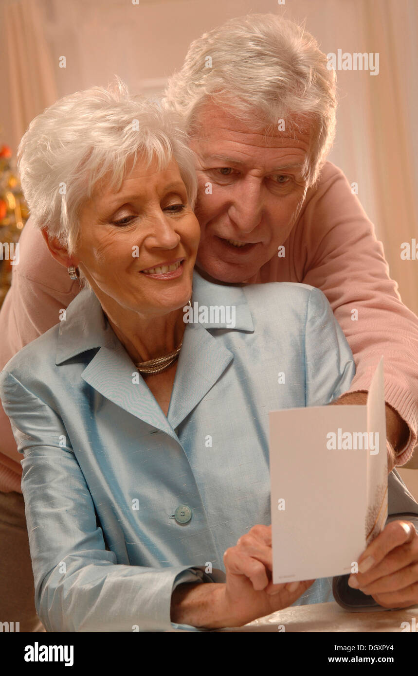Mature couple reading Christmas cards Stock Photo