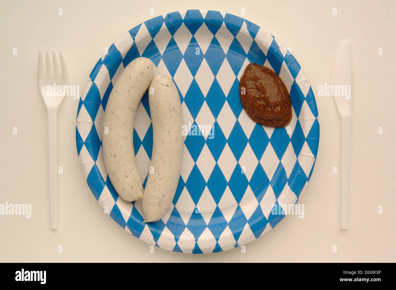 Weisswurst veal sausage with mustard on a paper plate with the Bavarian diamond pattern Stock Photo