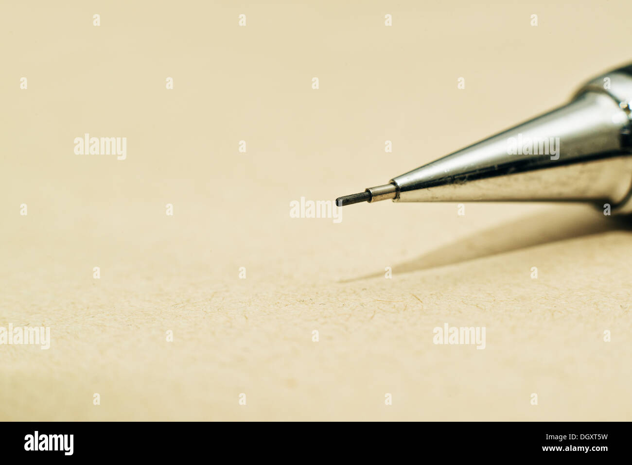Tip of sharp mechanical pencil on yellow paper Stock Photo