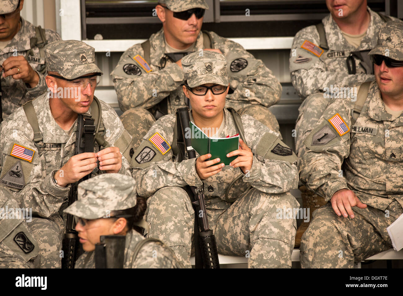 Male and female Drill Sergeant candidates at the US Army Drill Instructors School Fort Jackson study before being tested on marching drills September 26, 2013 in Columbia, SC. While 14 percent of the Army is women soldiers there is a shortage of female Drill Sergeants. Stock Photo