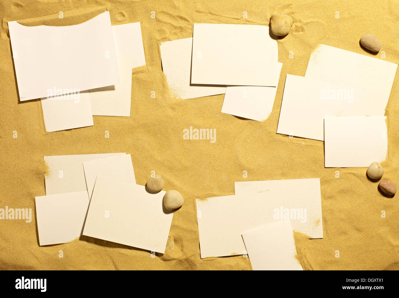photo sized pieces of paper on a sandy beach Stock Photo