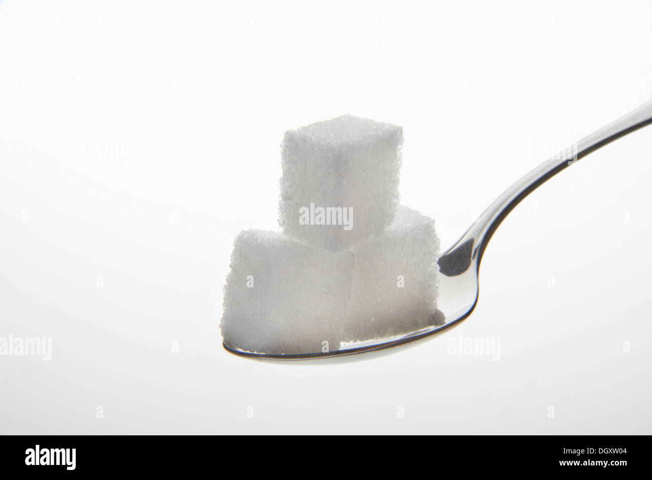 Teaspoon with three sugar cubes Stock Photo