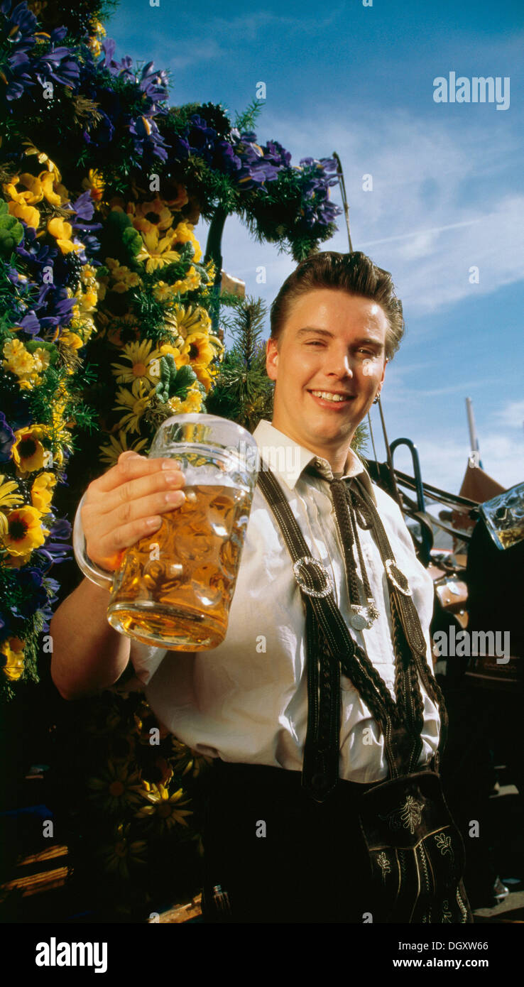 Man in Bavarian costume with a beer mug in his hand, Oktoberfest, Theresienwiese, Munich, Upper Bavaria, Bavaria, Germany Stock Photo