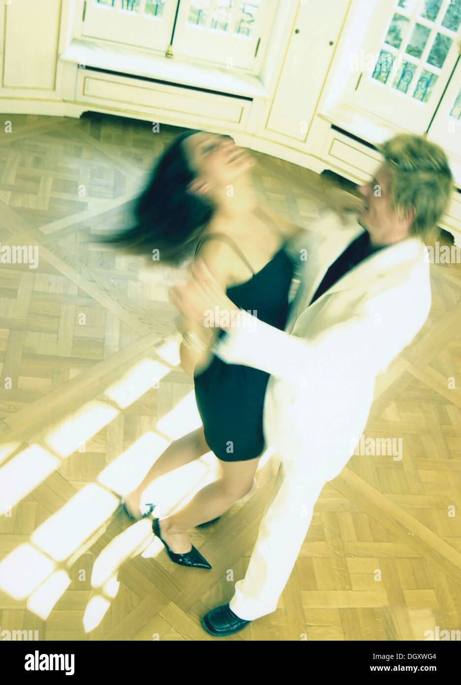 Dancing couple on herringbone parquet flooring Stock Photo