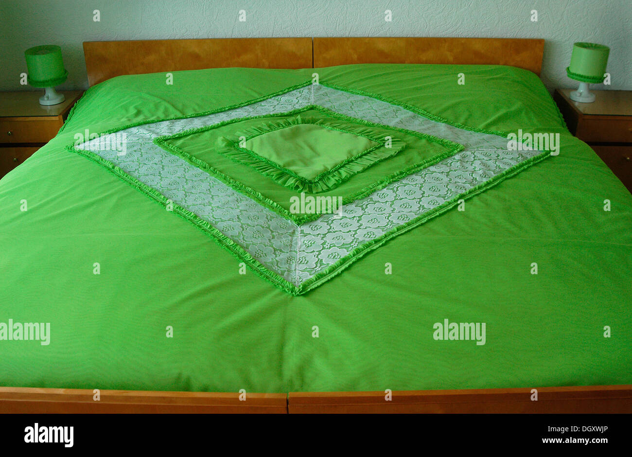 Double bed with a green bedspread Stock Photo