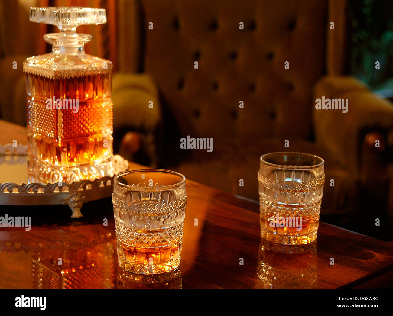 Two filled whiskey glasses and a decanter Stock Photo Alamy