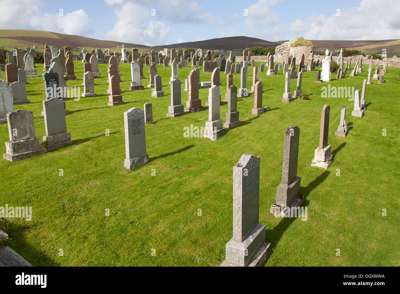 Islands of Orkney, Scotland. The Orphir graveyard with the ruined remains of the Orphir Round Kirk in the background. Stock Photo