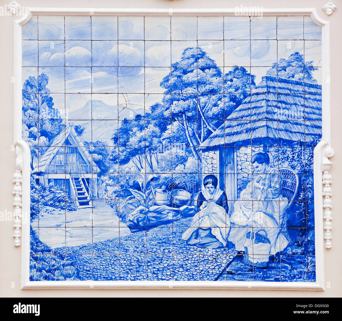Azulejo, mural made of painted ceramic tiles, rural scene, two women sewing and stitching, on the local theatre in Funchal Stock Photo