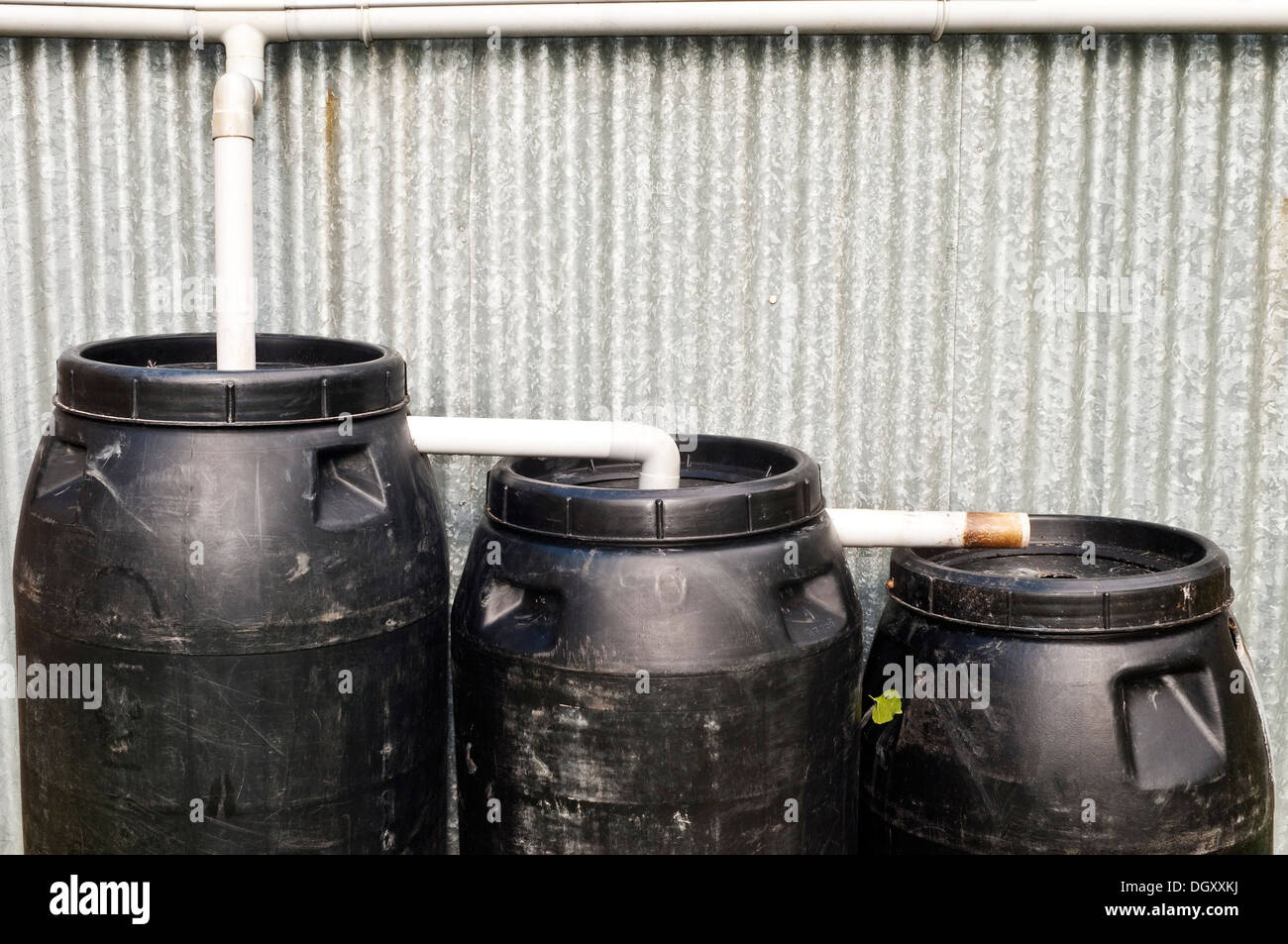 Three black plastic rainwater butts - France. Stock Photo