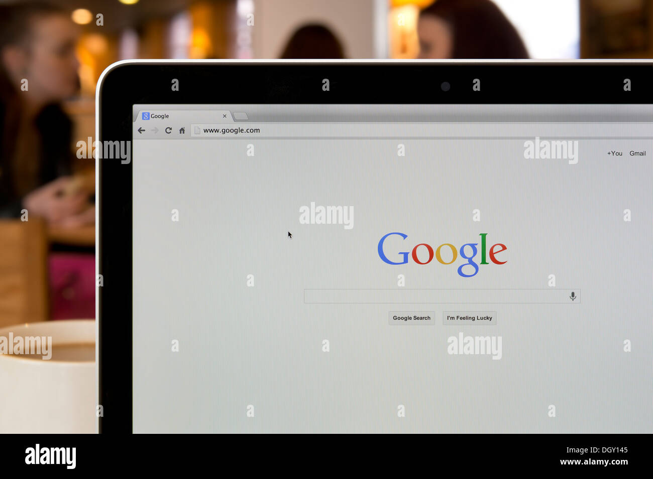 The Google website shot in a coffee shop environment (Editorial use only: print, TV, e-book and editorial website). Stock Photo