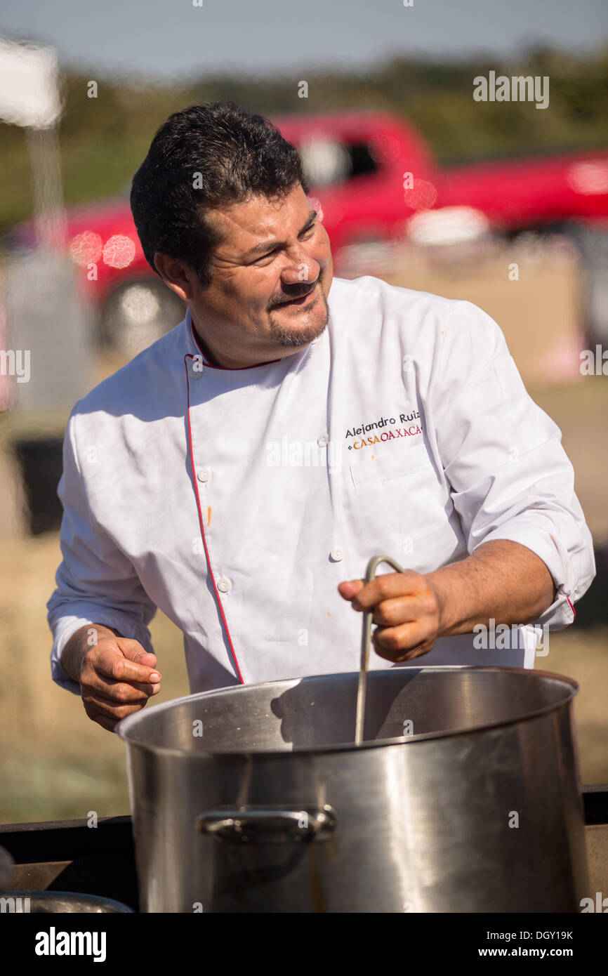 Chef Alejandro Ruiz of Casa Oaxaca prepares a meal during Cook it Raw outdoor BBQ event on Bowen's Island October 26, 2013 in Charleston, SC. Stock Photo
